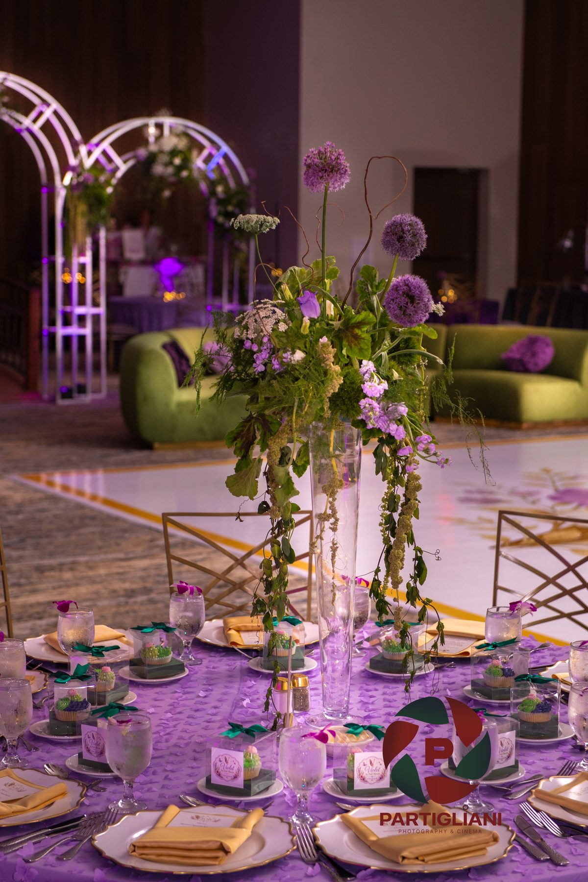 Long candlelit dinner table styled for a rehearsal dinner